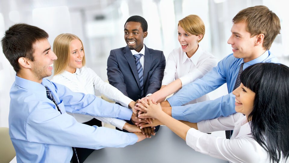 Stock image of business people in a huddle.